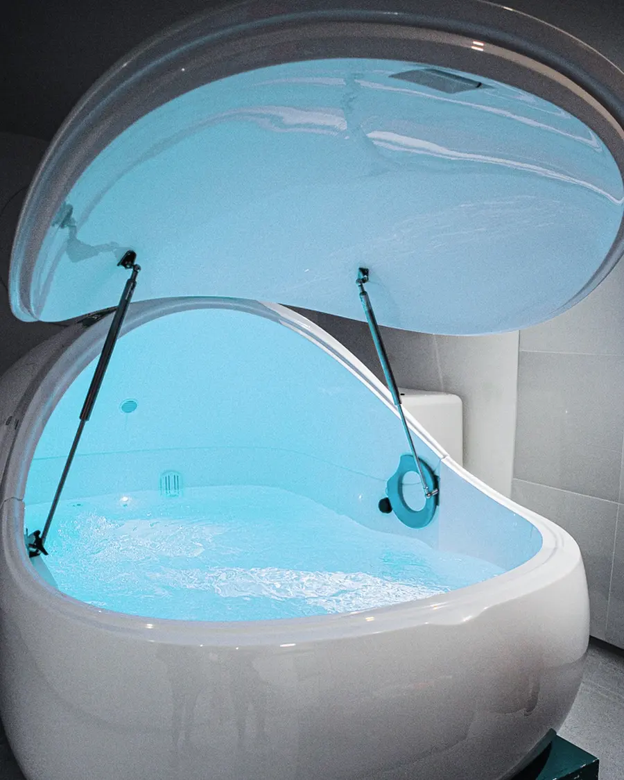 The float pod with its lid raised, lit from within.